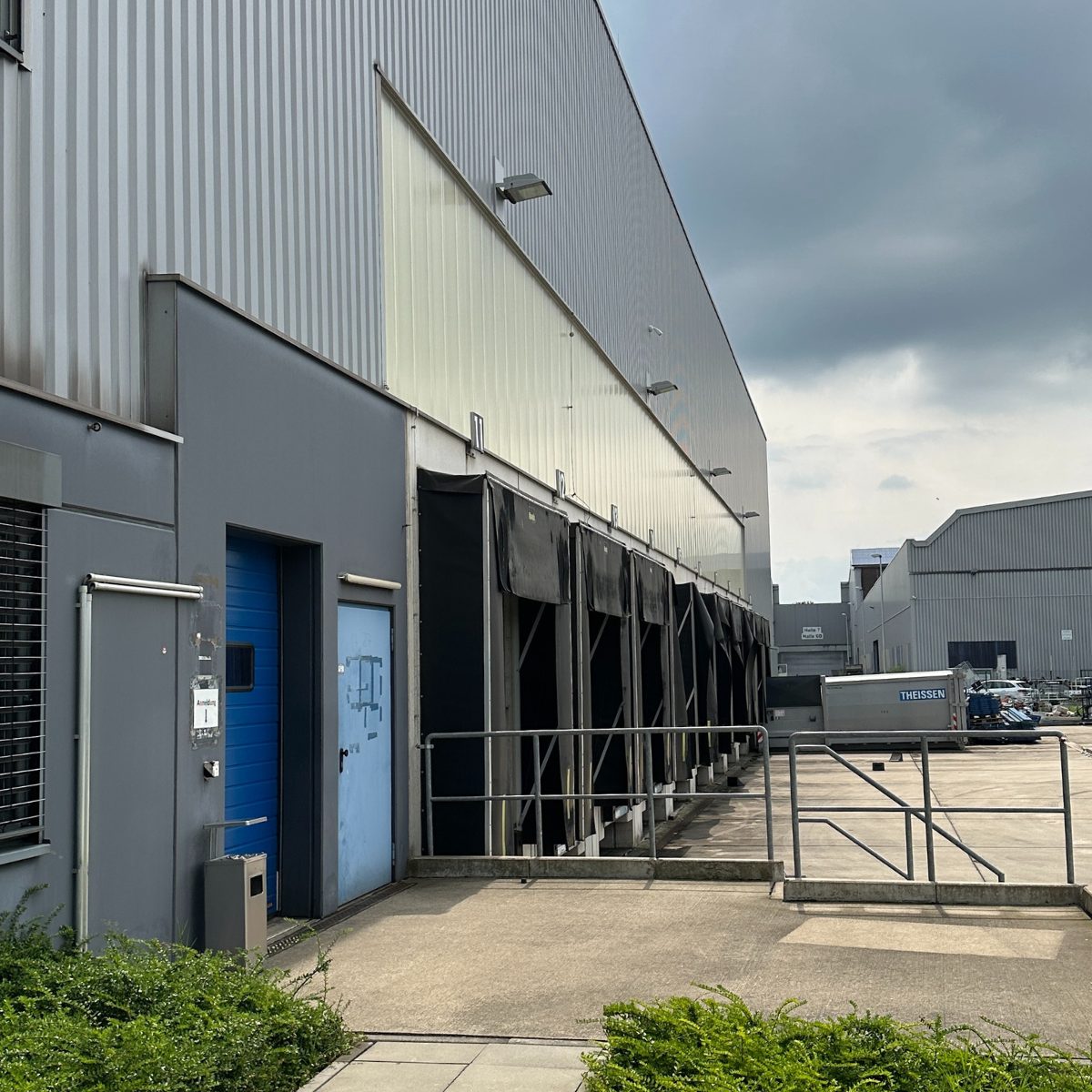 Exterior view of a WM GROUP logistics hall with loading docks and dock shelters