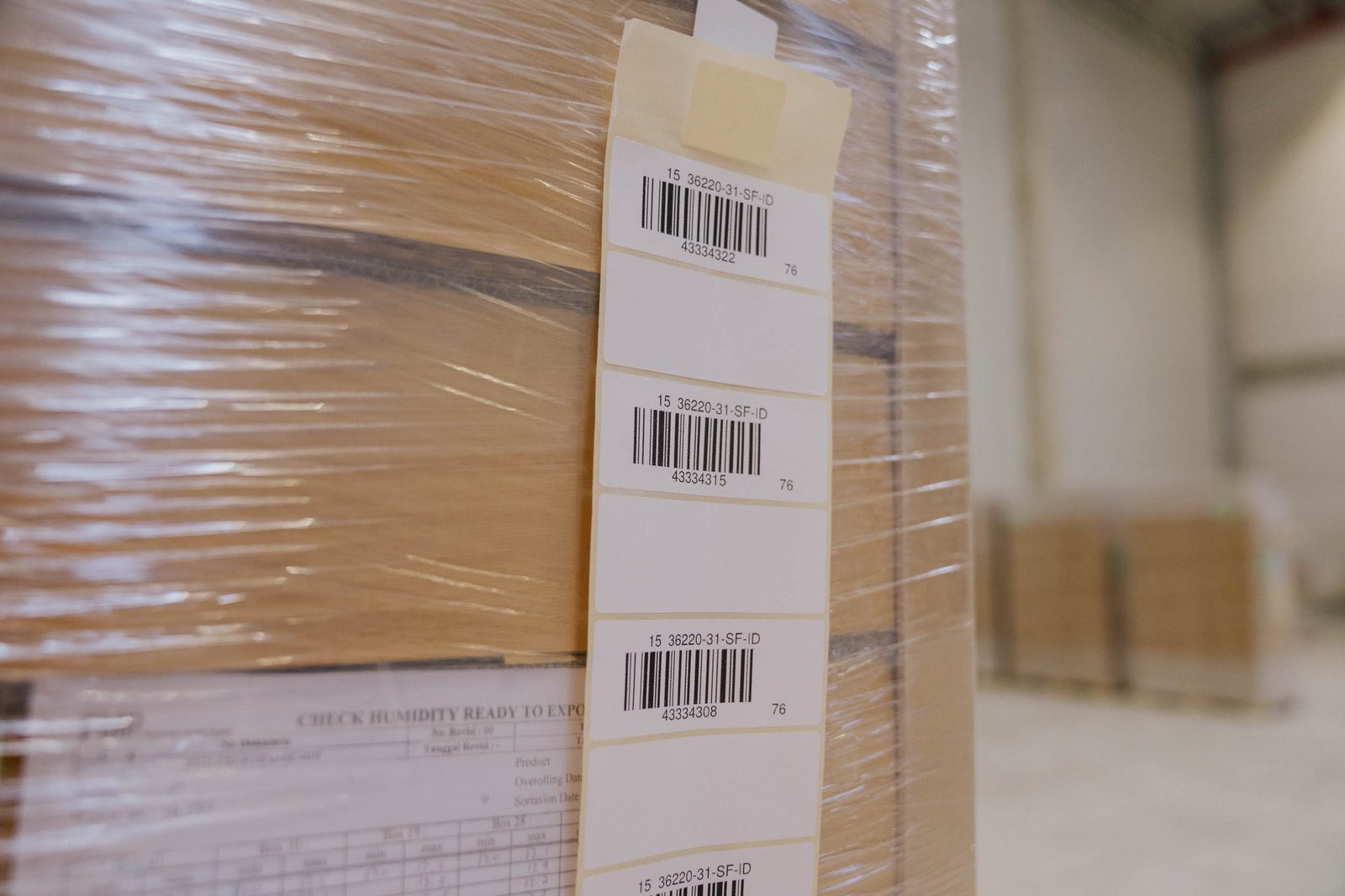 A wrapped pallet, the labels of the units inside readable through the film.