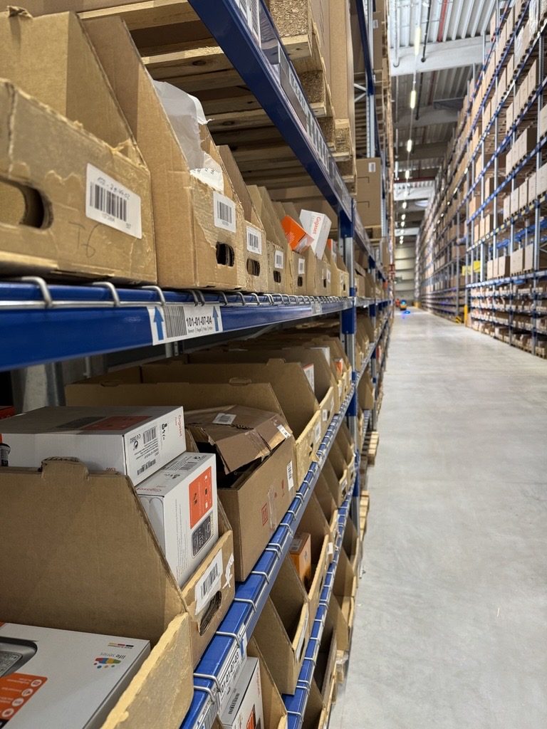 Shelving with pick boxes for order picking, pallet racking behind