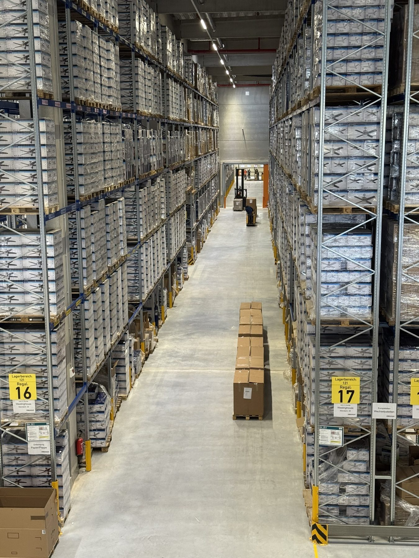View down a high-bay aisle in Bocholt 1, pallets stored to ceiling height on both sides