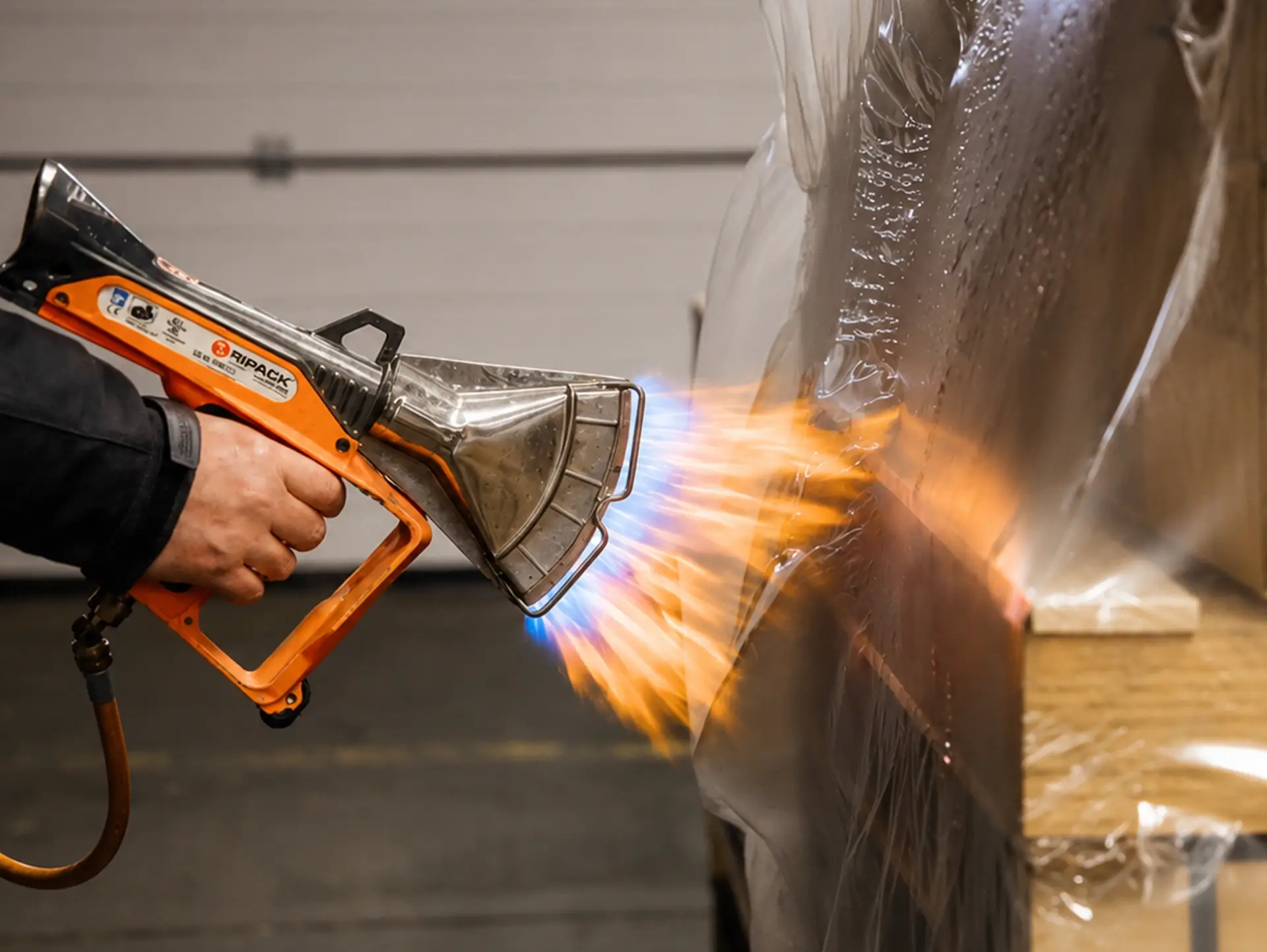WM GROUP employees shrink-wrap a large item.